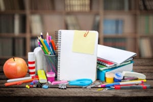 A desk with many school supplies on it